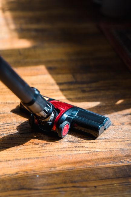 Vacuuming a car's interior floor during detailing